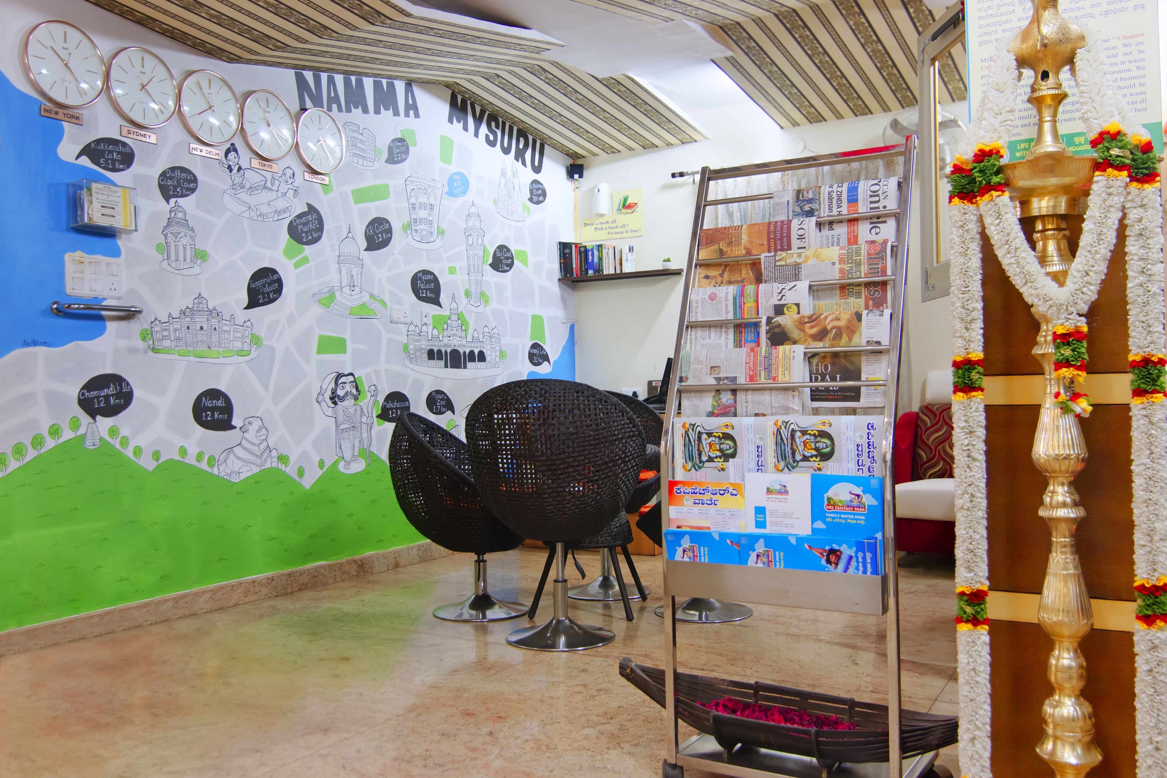 A room with a wall map, a bookshelf, and a decorative lamp.