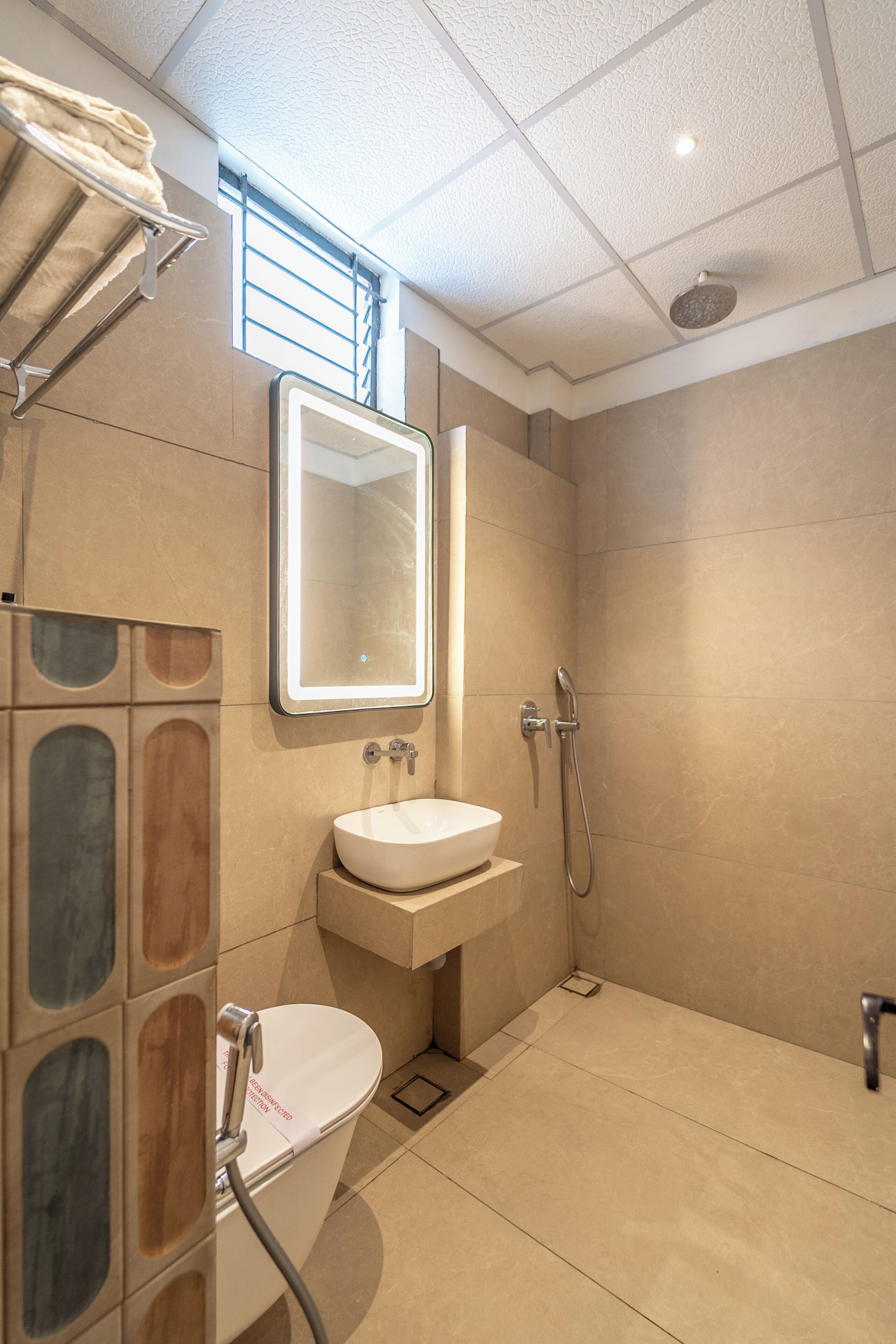 A modern bathroom with a toilet, sink, and shower.
