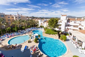 A resort with a large swimming pool, lounge chairs, and a view of the surrounding town. - Plazamar Serenity Resort (Calvia)