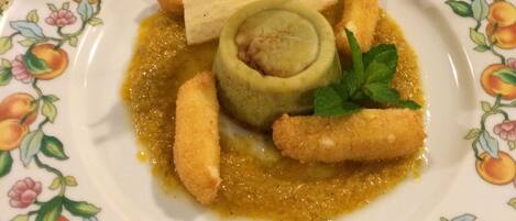 A plate with food, a glass, and a cloth.