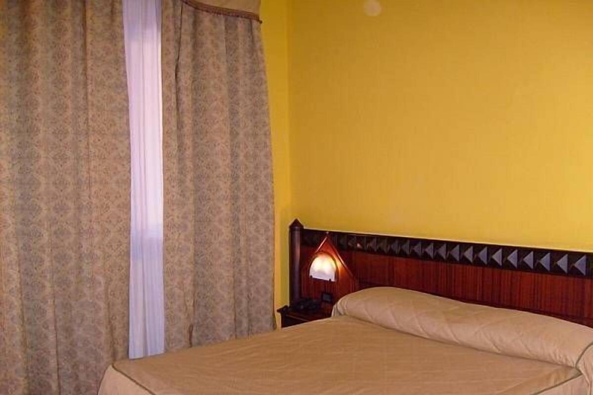 Standard Double Room | Minibar, individually furnished, desk, blackout drapes