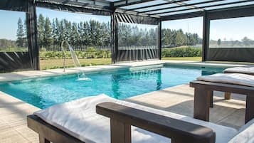 Indoor pool, outdoor pool, pool umbrellas, pool loungers