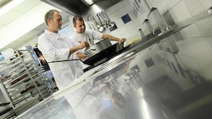A professional kitchen with stainless steel appliances and a reflective countertop. - Au Lion d'Or (Burnhaupt-le-Haut)