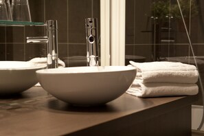 A bathroom with two sinks, a glass shelf, and a towel rack. - Le Carmin (Vitry-sur-Seine)