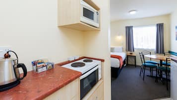Standard Suite, 1 Bedroom, Non Smoking, Kitchen | Desk, laptop workspace, blackout drapes, iron/ironing board