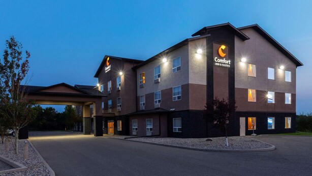A Comfort Inn & Suites hotel with a modern design, featuring multiple floors and a covered entrance.