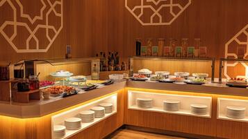 A buffet area with various food stations and a wooden interior design.