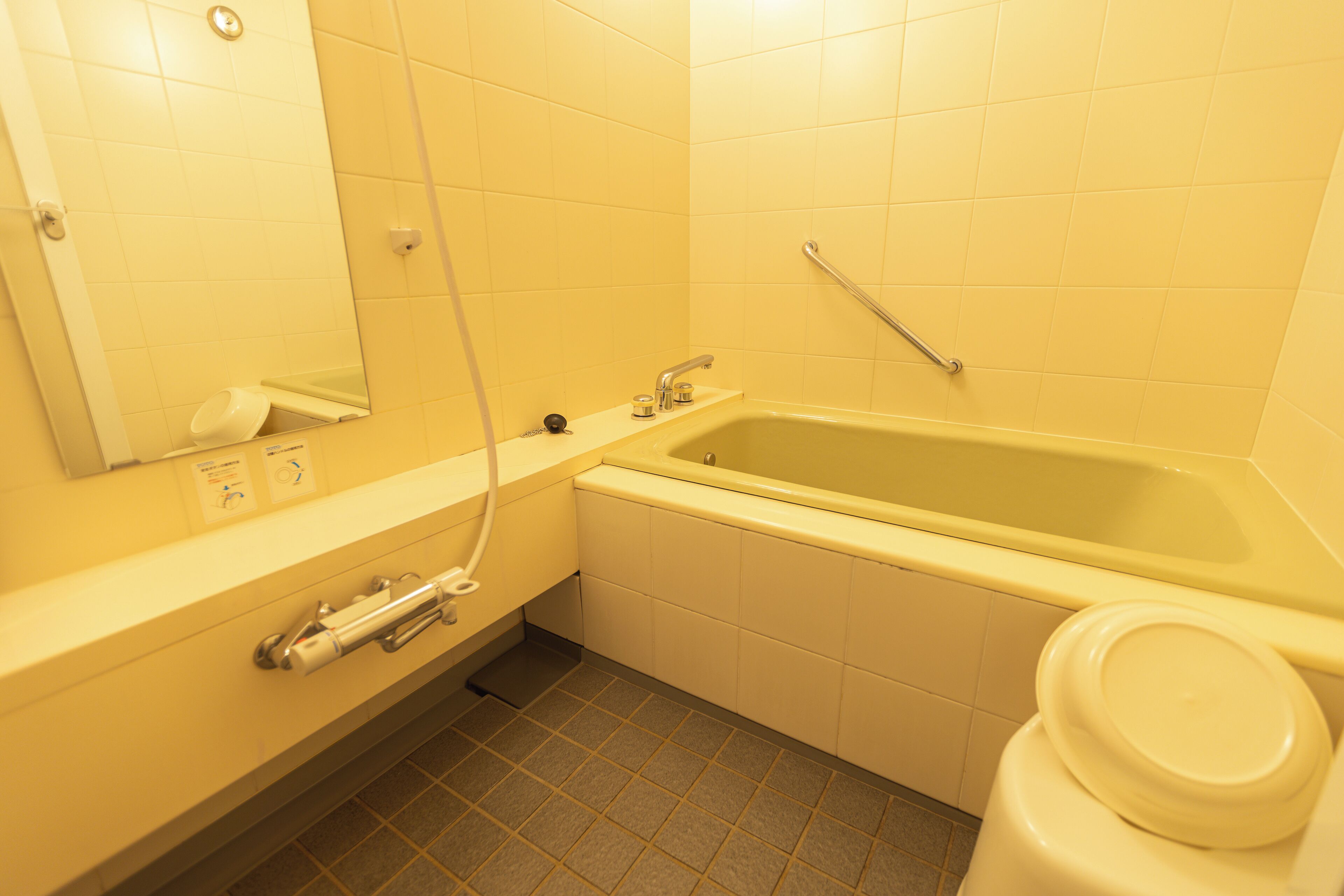 A bathroom with a bathtub, toilet, and sink.