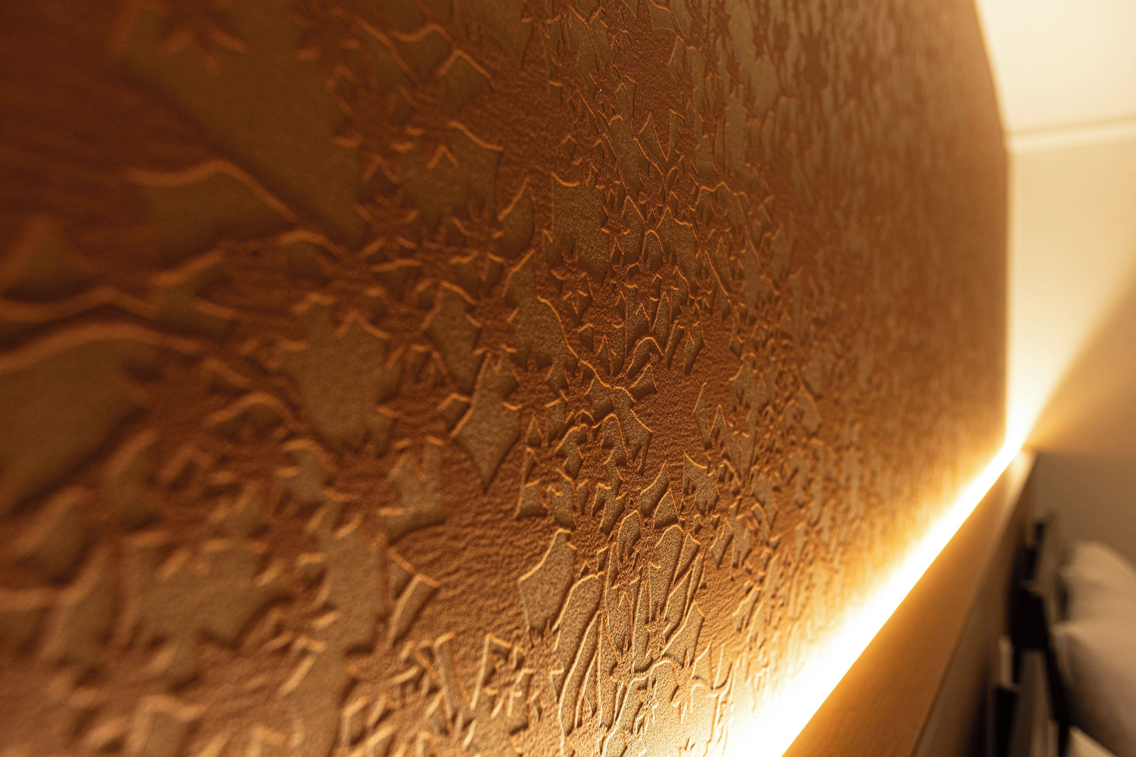 A textured wall with a warm, illuminated edge.