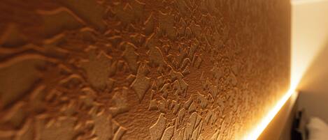 A textured wall with a warm, illuminated edge.