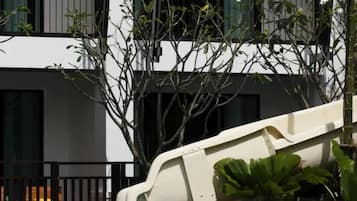 A modern building with multiple windows and a white facade.