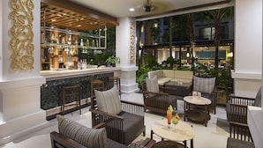A modern lounge area with seating, a bar, and large windows overlooking a garden. - Centara Anda Dhevi Resort and Spa Krabi (Krabi)
