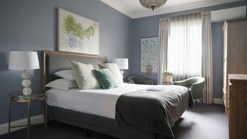 Cozy retreat with a large bed, bedside tables, and a comfortable chair.