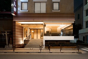 A hotel entrance with a modern design, a staircase leading to the lobby, and a glass facade. - Ueno First City Hotel (Tokyo)