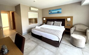 A hotel room with a large bed, bedside tables, a chair, a desk, and a window. - Marina Boutique Fethiye - Boutique Class (Fethiye)