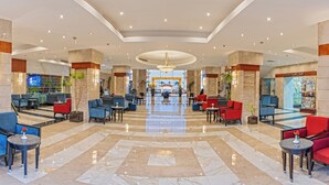 A hotel lobby with a marble floor, seating areas, and a view of the entrance. - Xperience Sea Breeze Resort (Sharm El Sheikh)