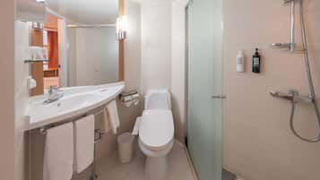 Eco-friendly toiletries, hair dryer, slippers, bidet