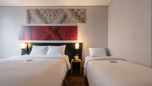 A hotel room with two beds, a nightstand with a lamp, and a wall-mounted artwork above the beds. - Central Seven Hotel by Kwon Busan Seomyeon (Busan)