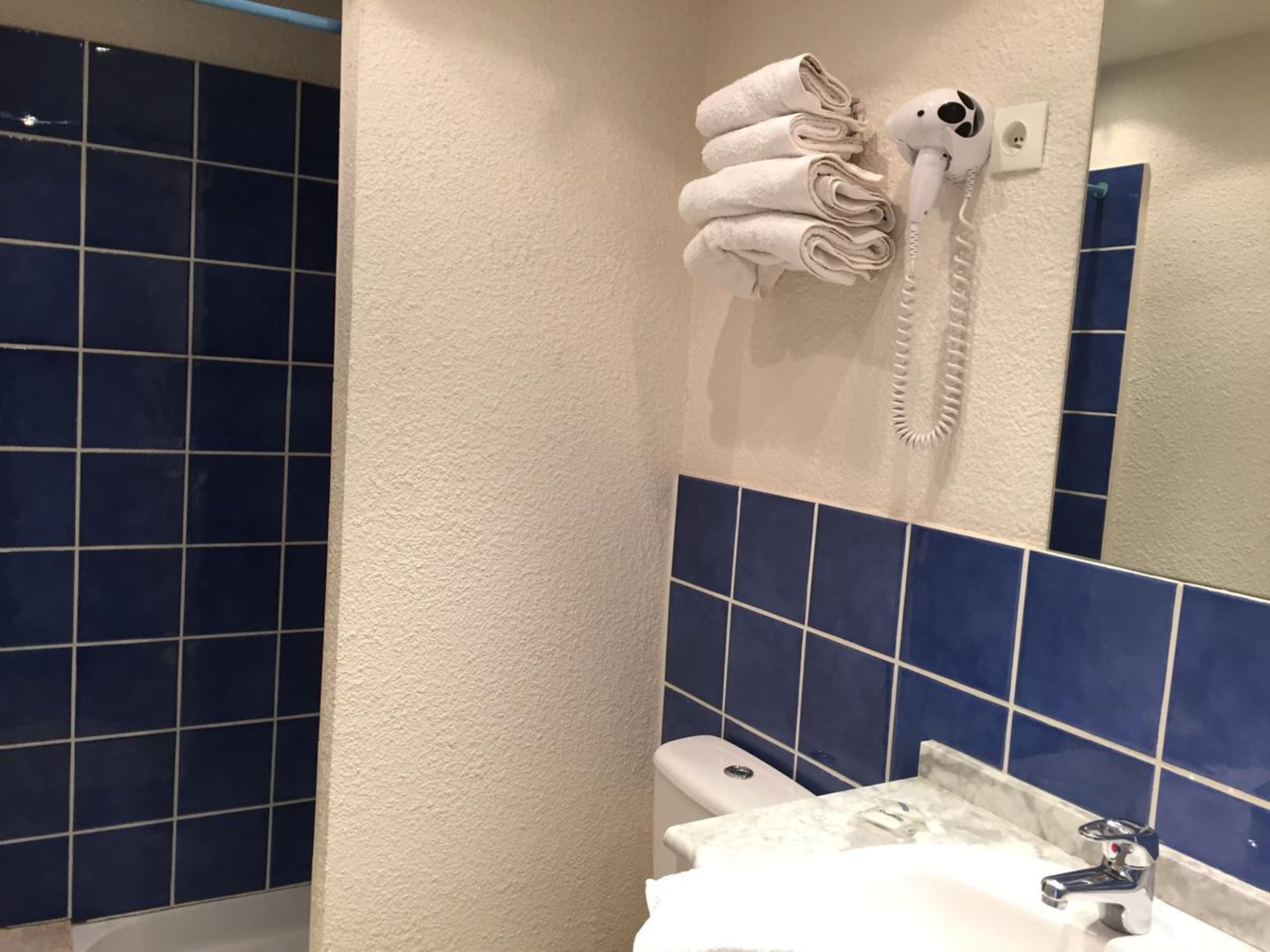 double room with shower | bathroom | hair dryer, towels, soap, toilet paper