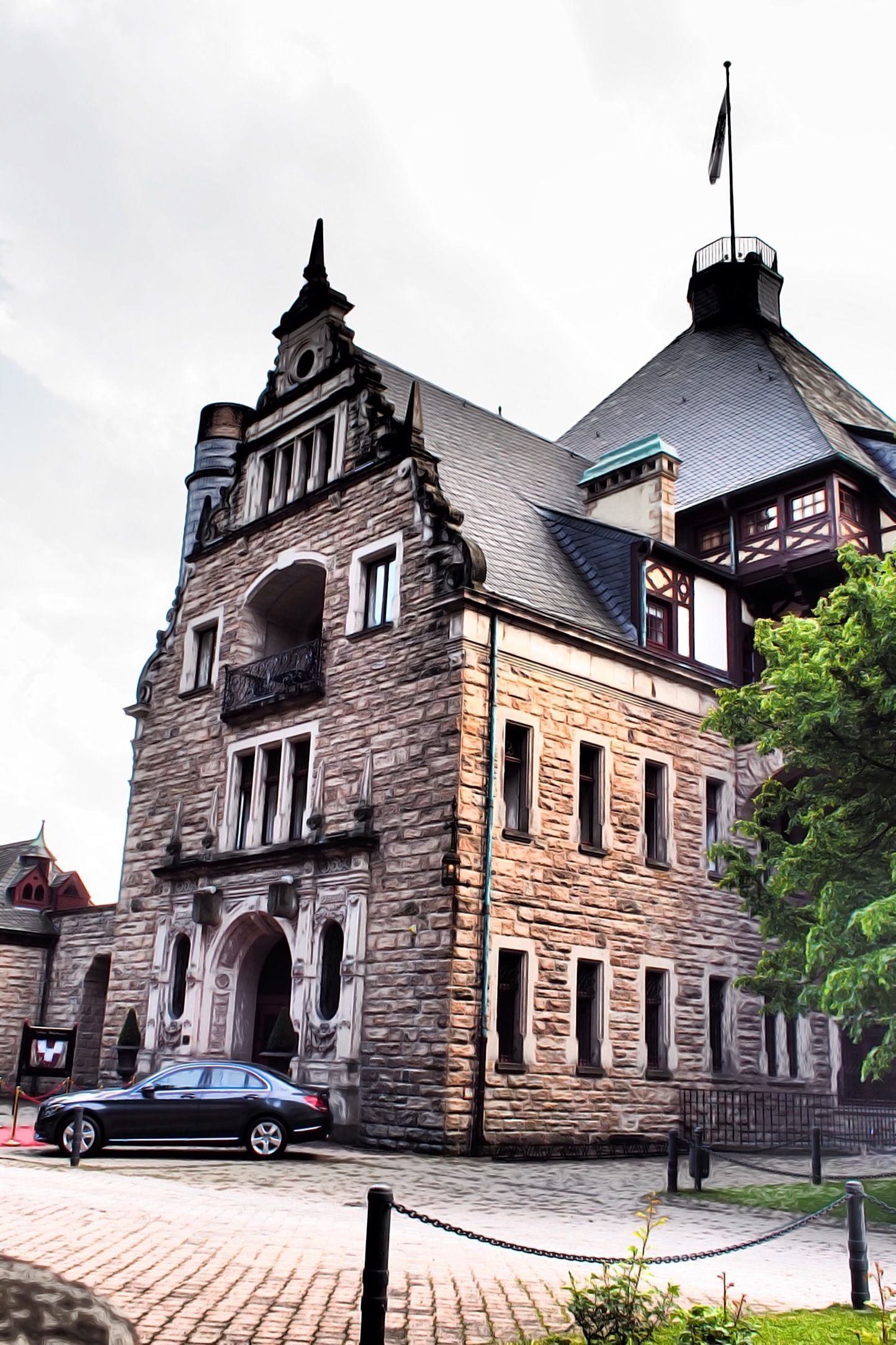 A historic stone building with a prominent tower and arched windows.