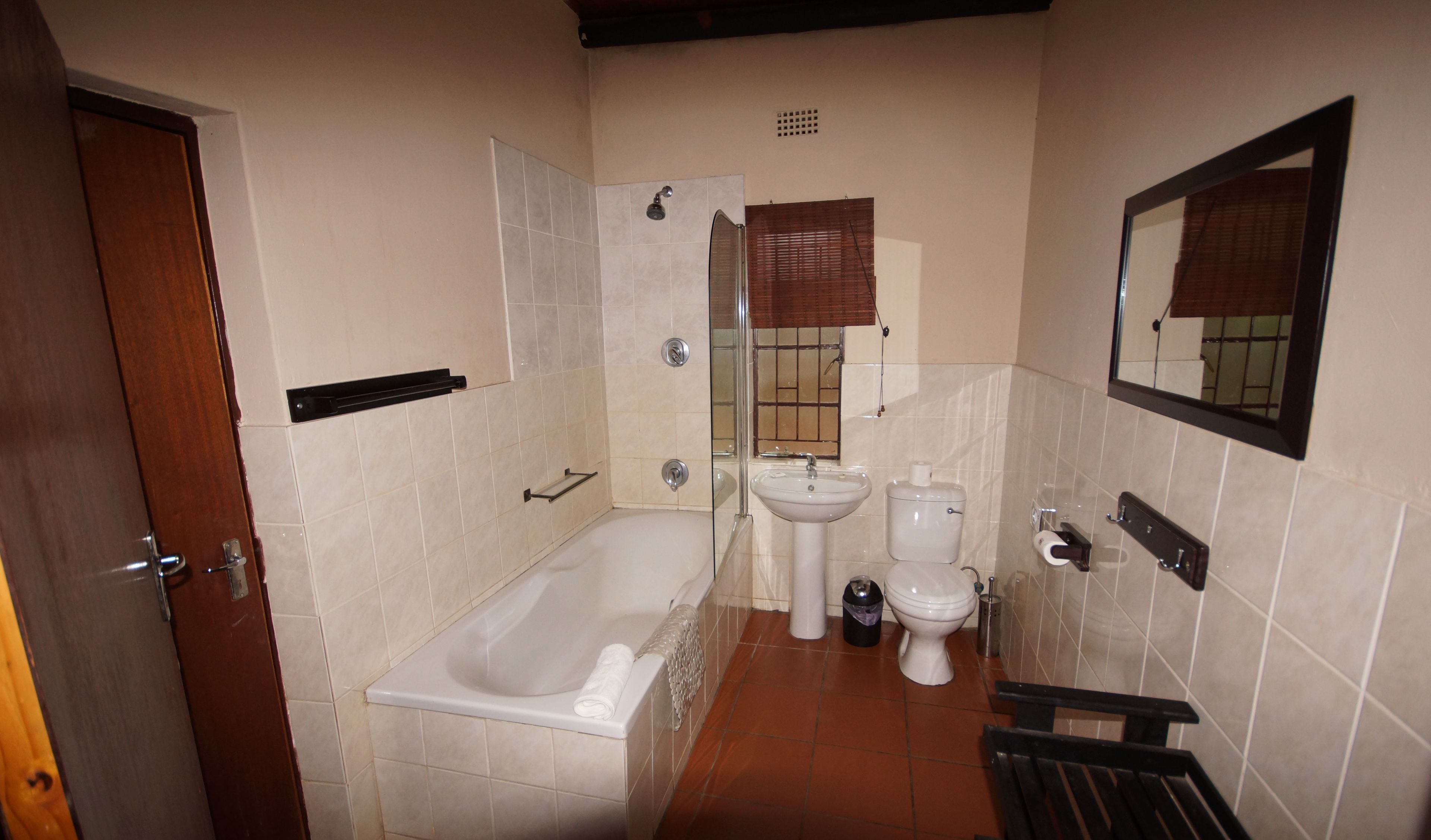 A bathroom with a bathtub, a sink, and a toilet.