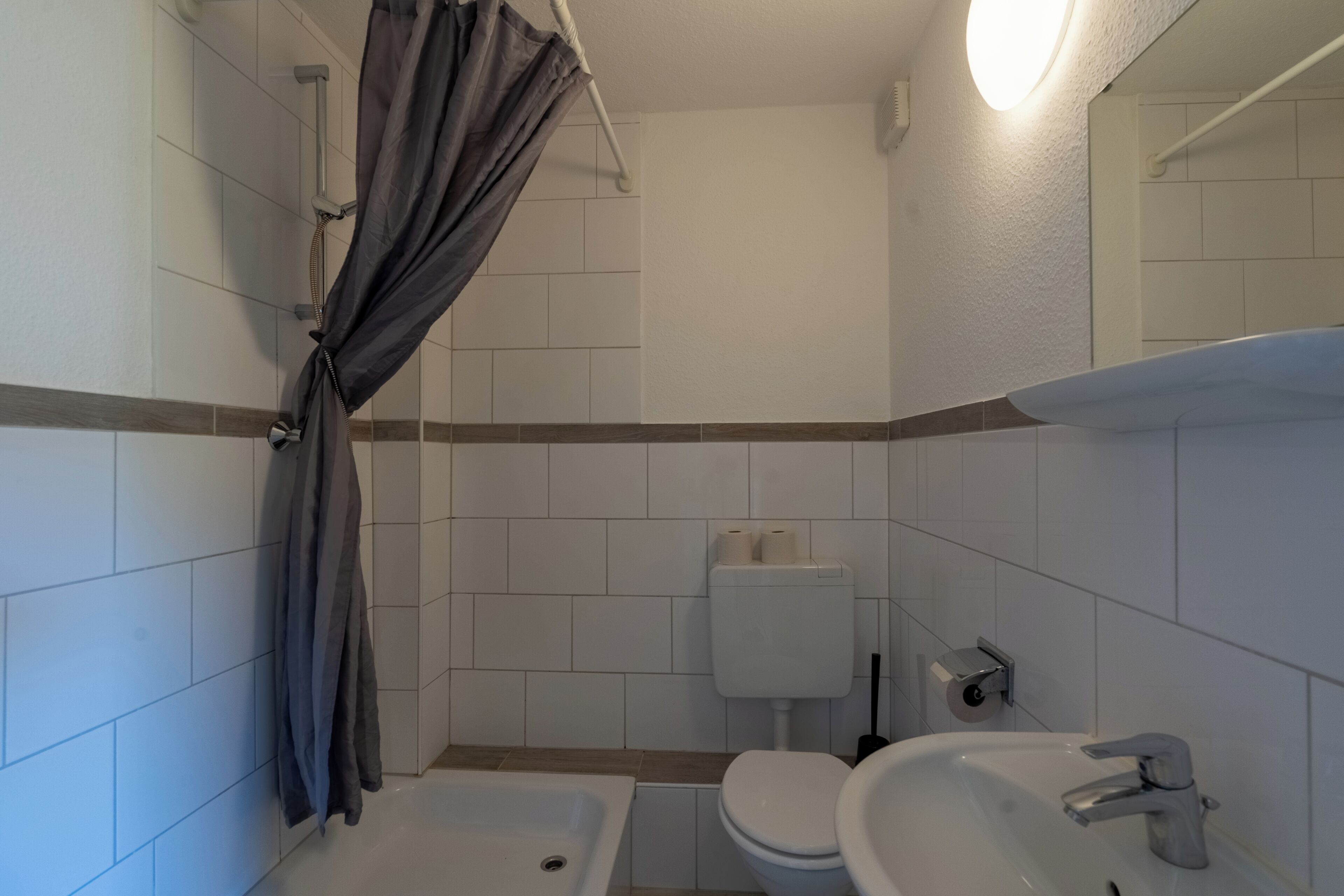 A bathroom with a bathtub, toilet, and sink.