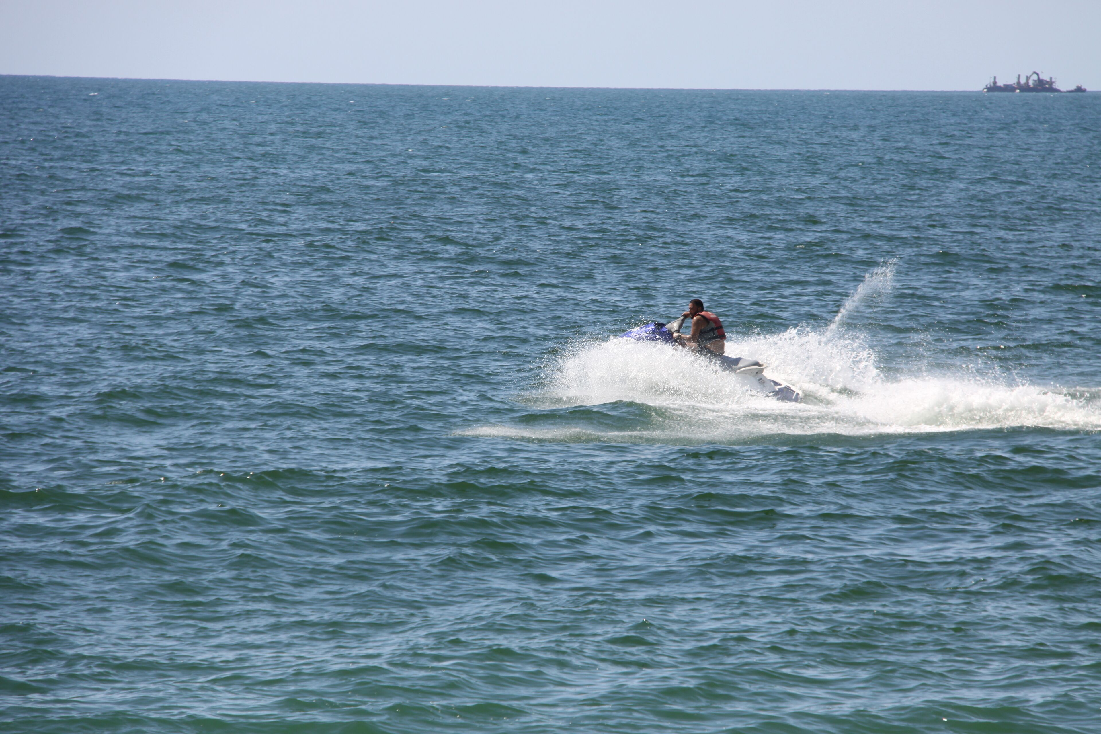A person jet-skiing on a large body of water.