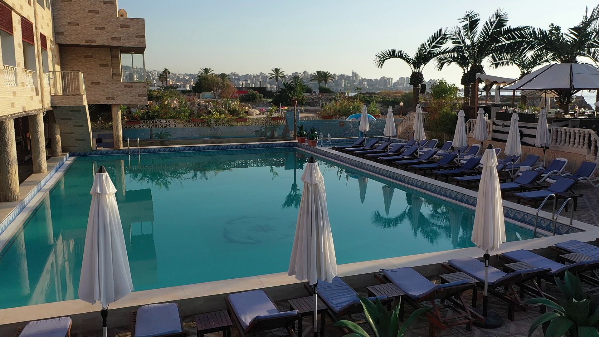 Seasonal outdoor pool, open 9:00 AM to 5:30 PM, pool umbrellas