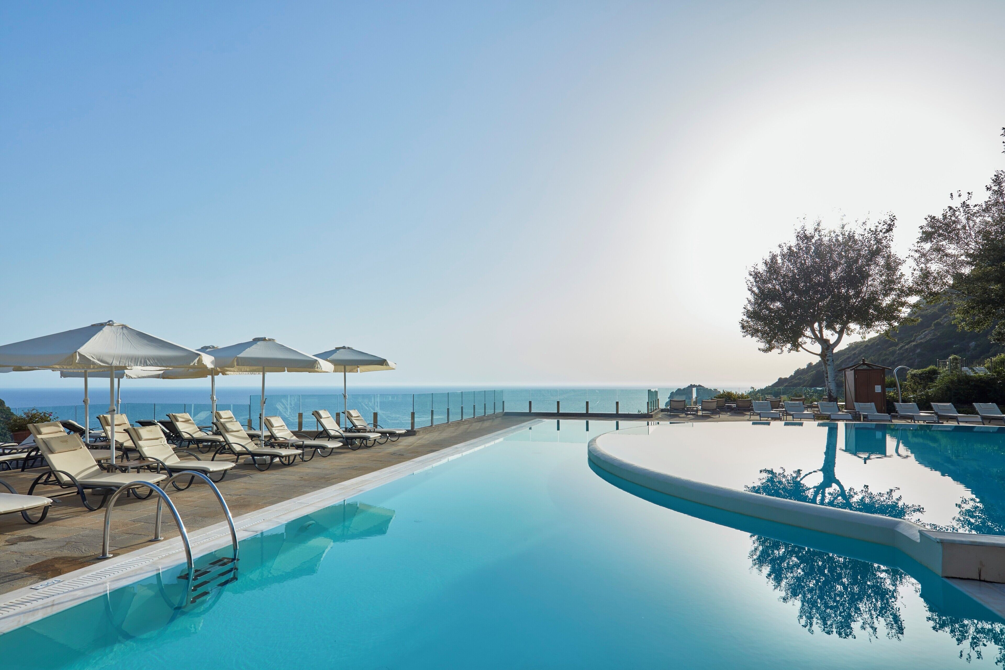 Indoor pool, outdoor pool, pool umbrellas, pool loungers