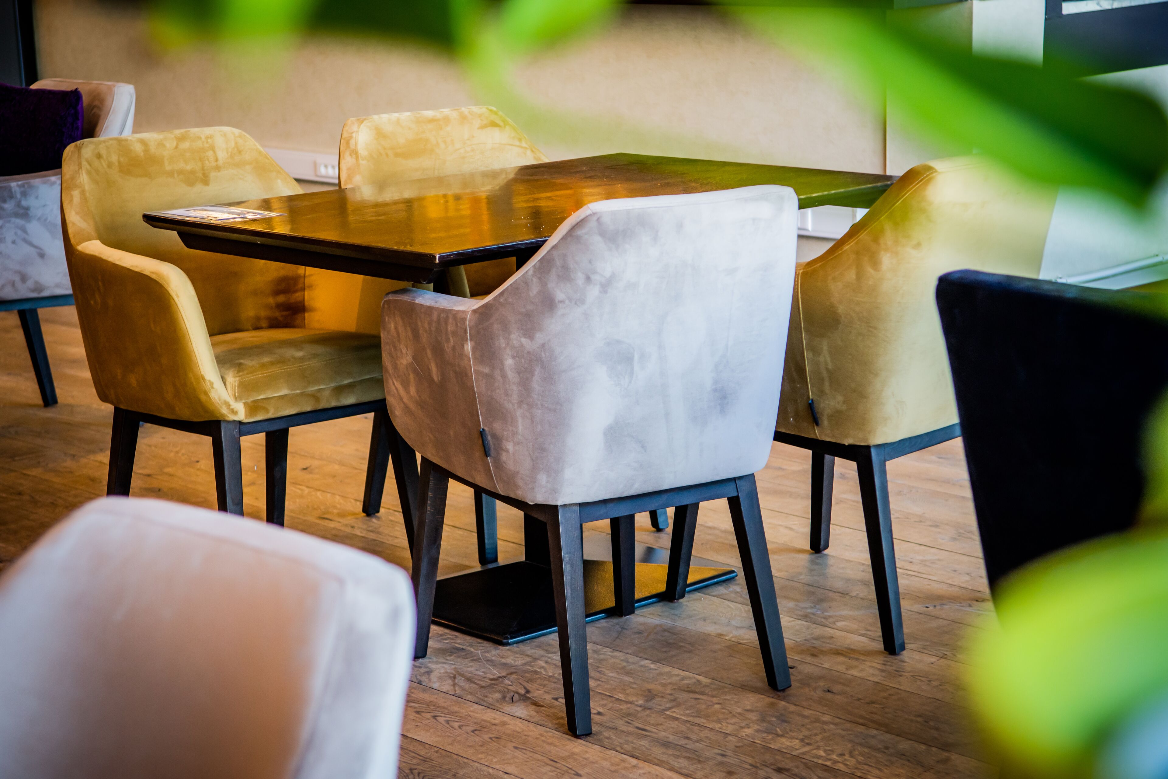 Een eethoek met een rechthoekige tafel en vier stoelen, waarvan er één wit is.