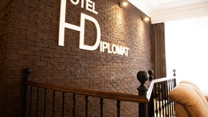 A hotel sign with the name "HOTEL HD DIPLOMAT" on a brick wall. - Hotel Diplomat (Tbilisi)