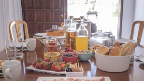 A breakfast table with various food items, including pastries, fruits, and beverages. - ETHOS Bertolina Wellness Urban Living. (Albufeira)