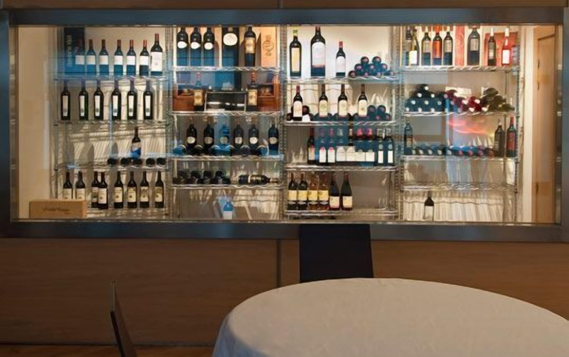 A wine display case with multiple shelves of wine bottles.