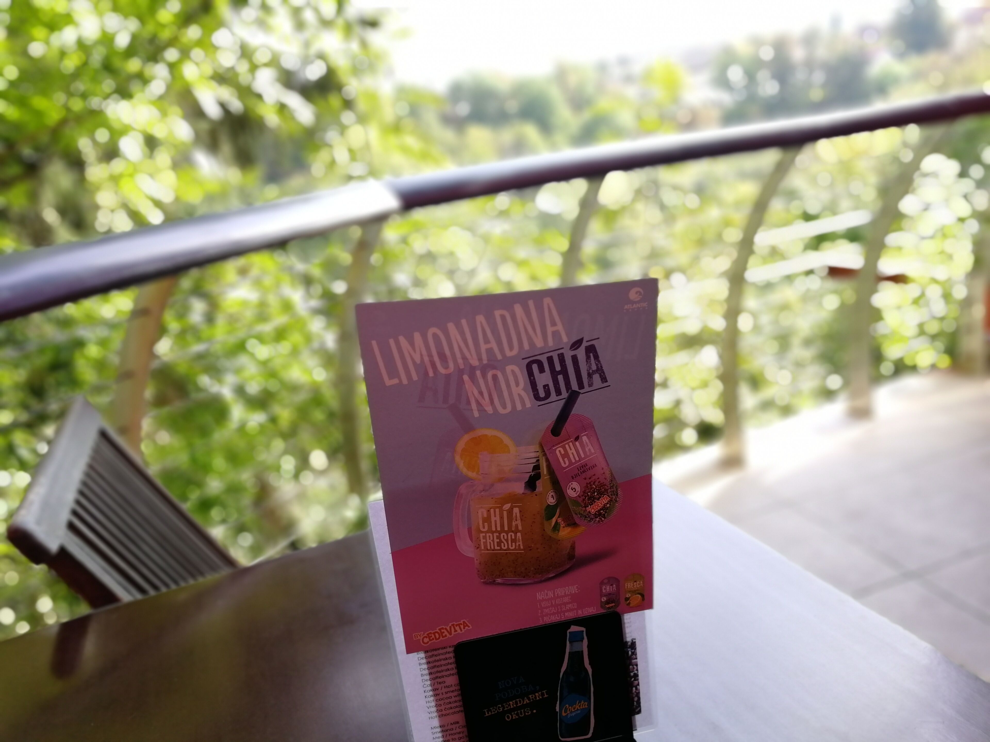 A poster with text and images of drinks on a table.