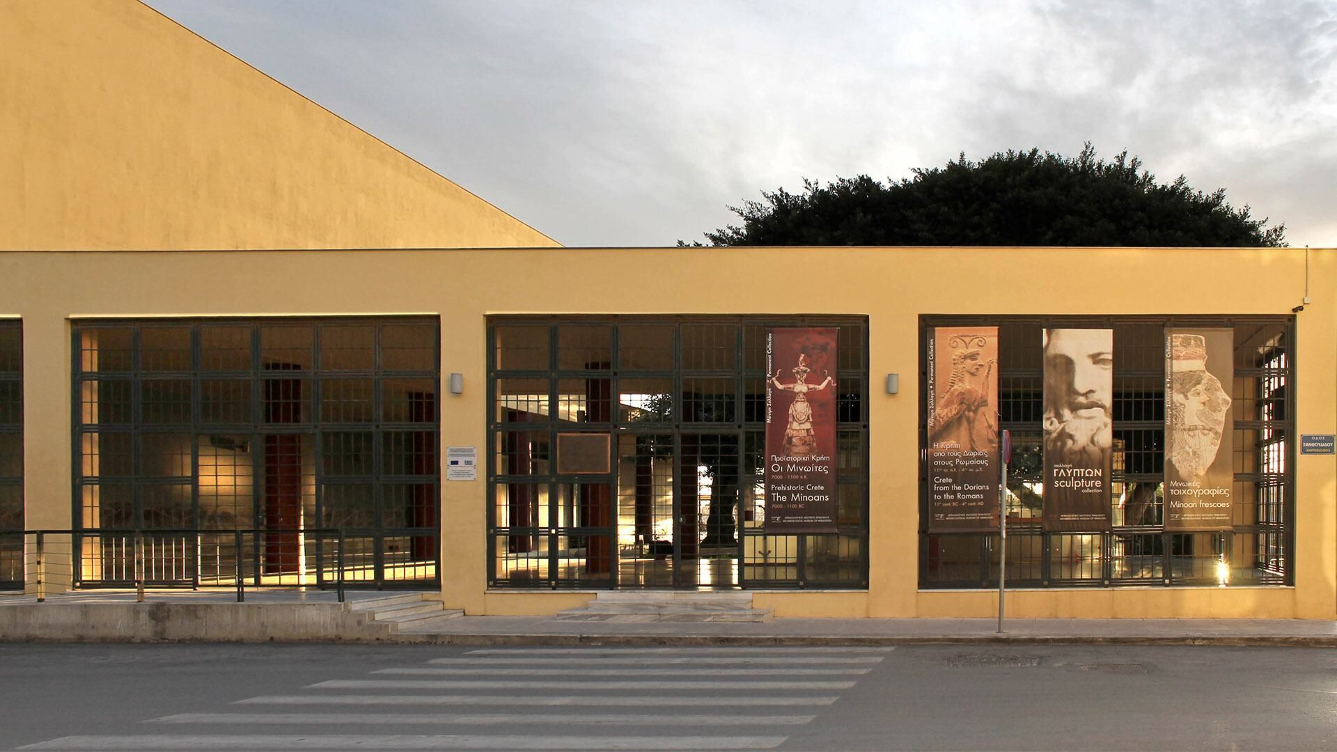 A building with large windows and posters on the facade.