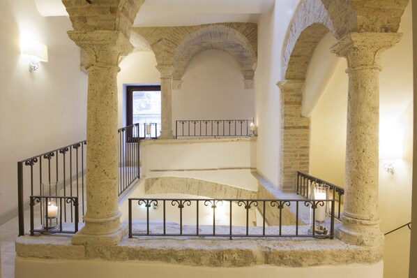 A stone staircase with railings, leading to an upper level.