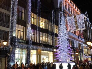 A building with multiple floors, large windows, and a storefront with illuminated signage.