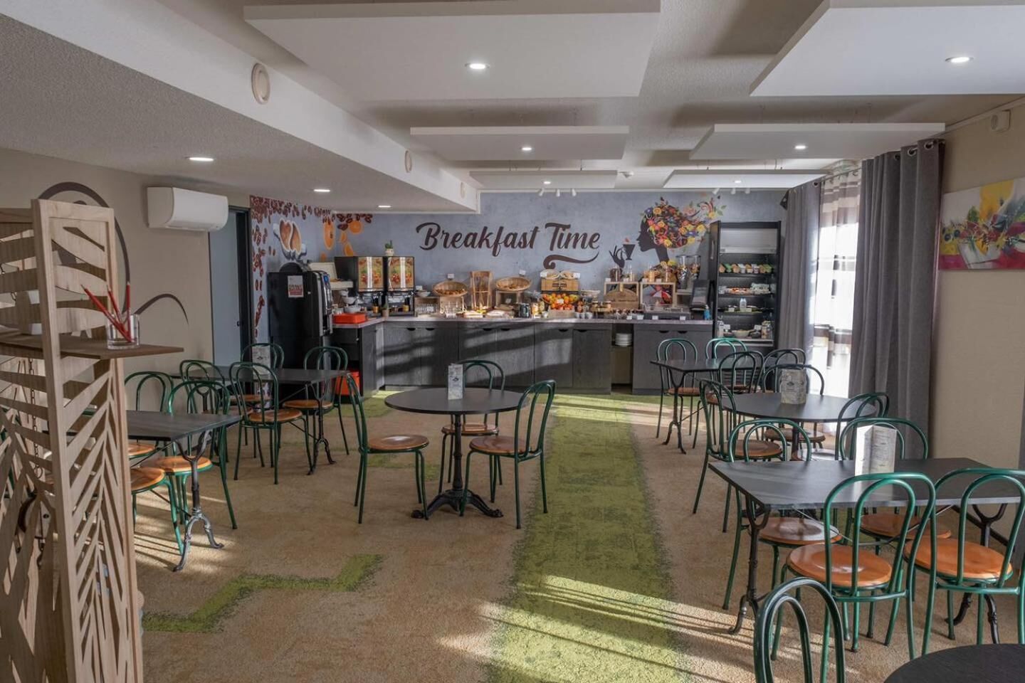 A breakfast area with a counter, chairs, and a wall with 'Breakfast Time' written on it.