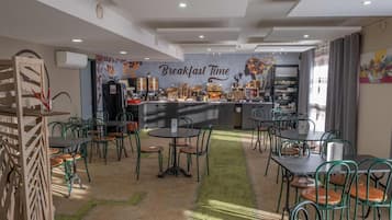A breakfast area with a counter, chairs, and a wall with 'Breakfast Time' written on it.