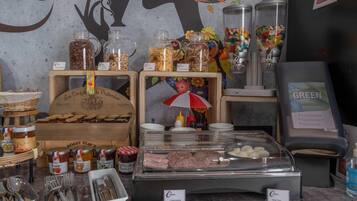 A breakfast buffet with various food items and condiments.