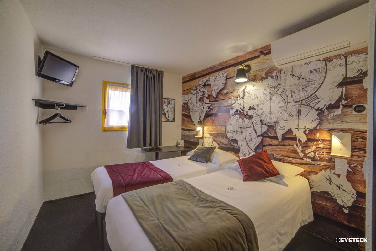 A hotel room with two beds, a world map on the wall, a flat-screen TV, and a window with curtains.