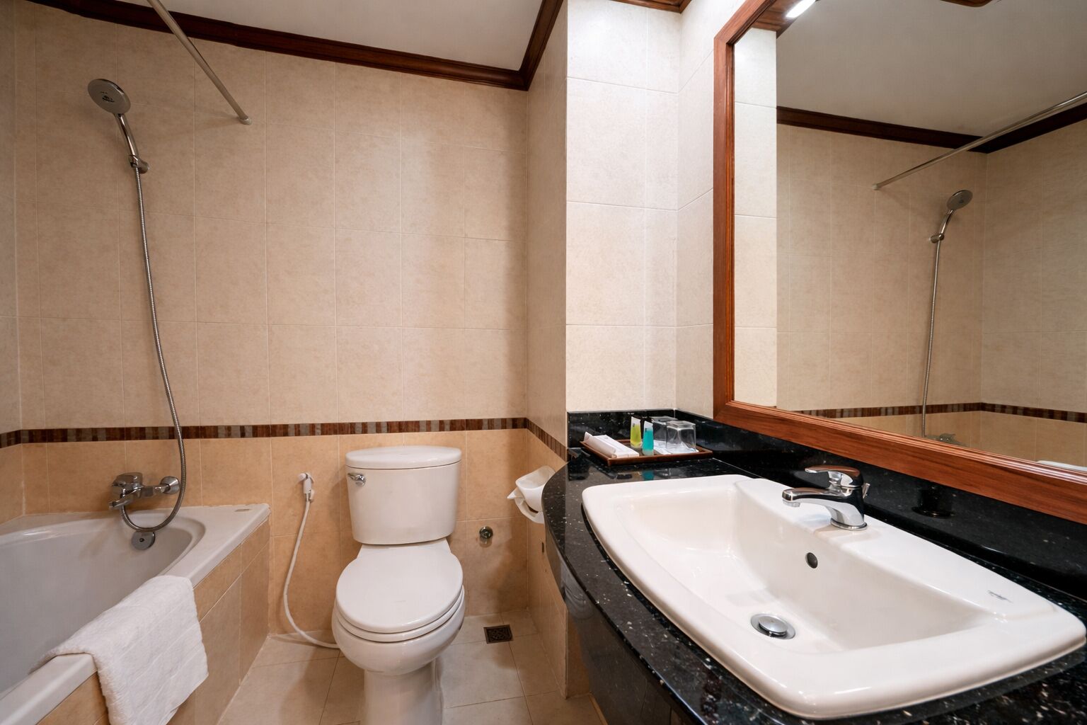 A bathroom with a toilet, a sink, a bathtub, and a shower.
