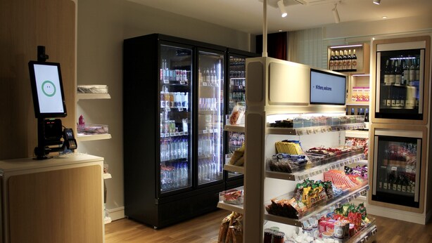 A modern retail store with refrigerated sections, a digital kiosk, and a variety of packaged goods. - Holiday Inn Express Amsterdam - Sloterdijk Station by IHG (Amsterdam)