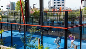 An indoor tennis court with multiple courts, surrounded by a netted enclosure. - Holiday Inn Express Amsterdam - Sloterdijk Station by IHG (Amsterdam)