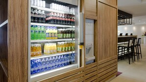 A vending machine stocked with various beverages in a modern setting. - Holiday Inn Express Amsterdam - Sloterdijk Station by IHG (Amsterdam)