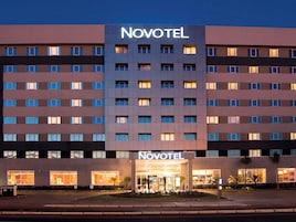 A hotel with a modern facade, multiple floors, and a prominent 'Novotel' sign.