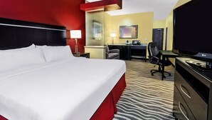 A hotel room with a large bed, a desk, a chair, a television, and a wardrobe. - Holiday Inn Express & Suites Cotulla by IHG (Cotulla)