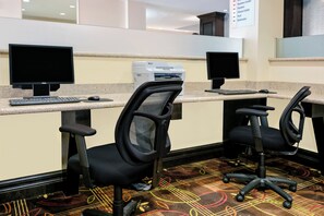 A reception area with two computer workstations, each with a monitor, keyboard, and mouse.