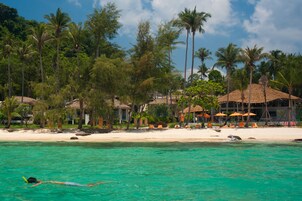 On the beach, white sand, sun loungers, beach umbrellas
