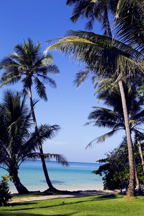 On the beach, white sand, sun-loungers, beach umbrellas